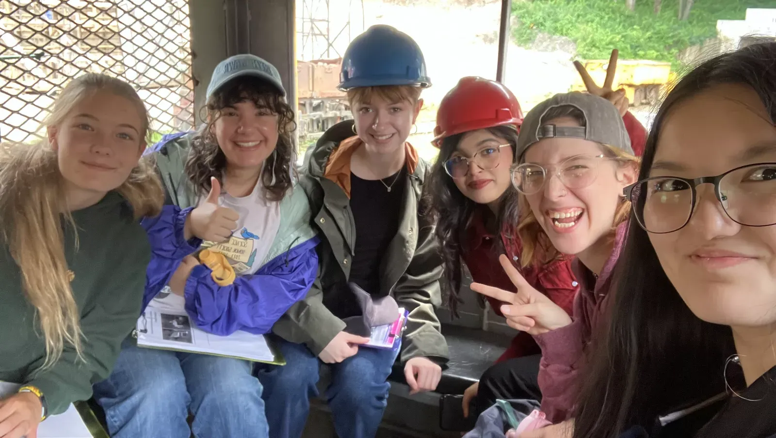 Fellows posing in train that takes them into the coal mine.